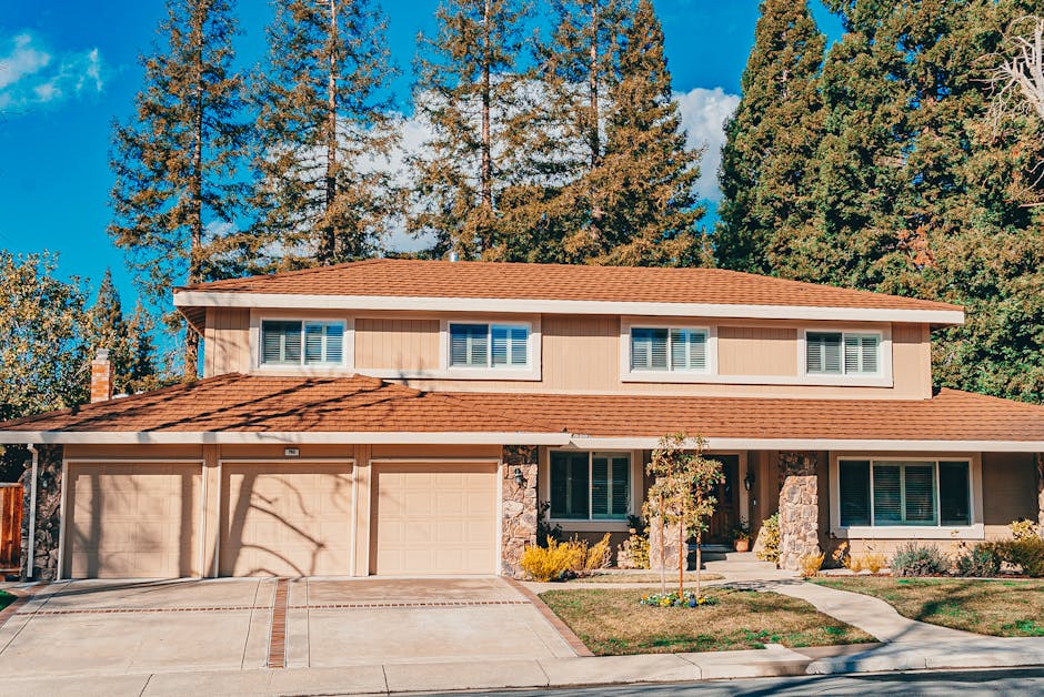 Beautiful front yard with a mature shade tree and well-maintained landscaping