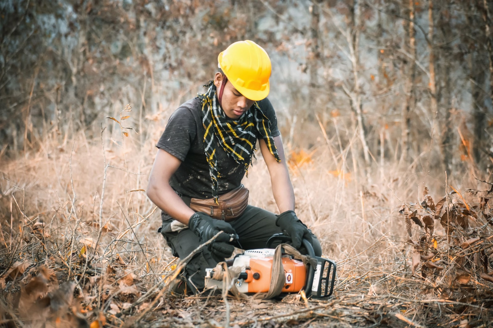 Chainsaw operator wearing full safety gear